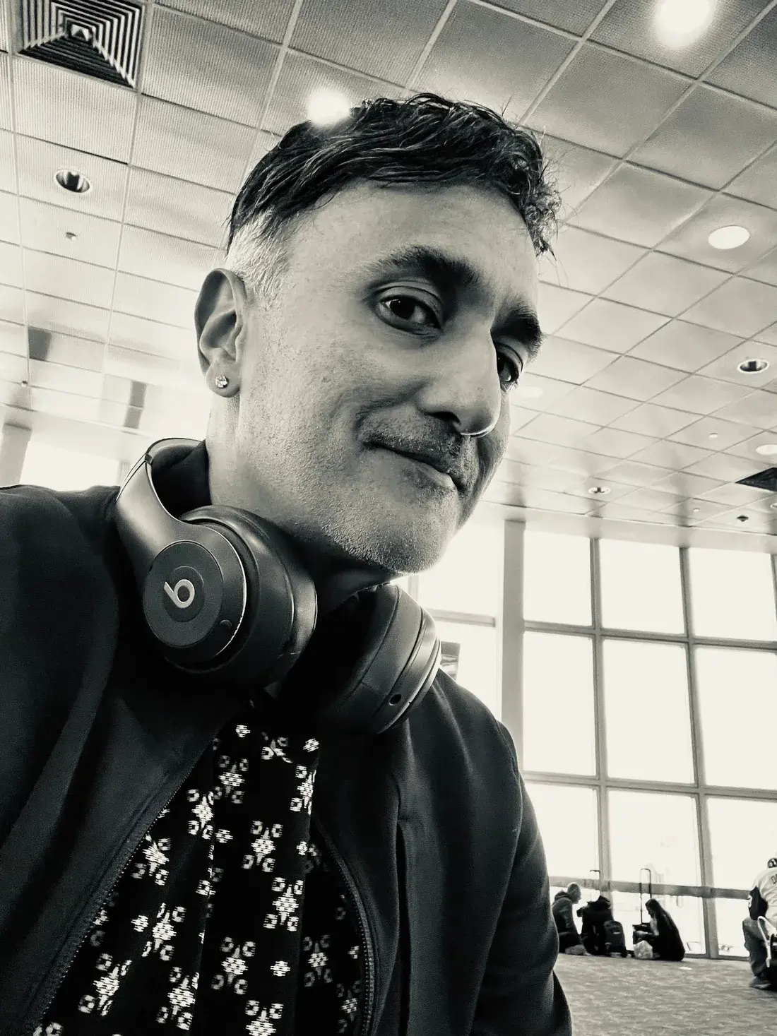 Candid black-and-white portrait of Neo with headphones