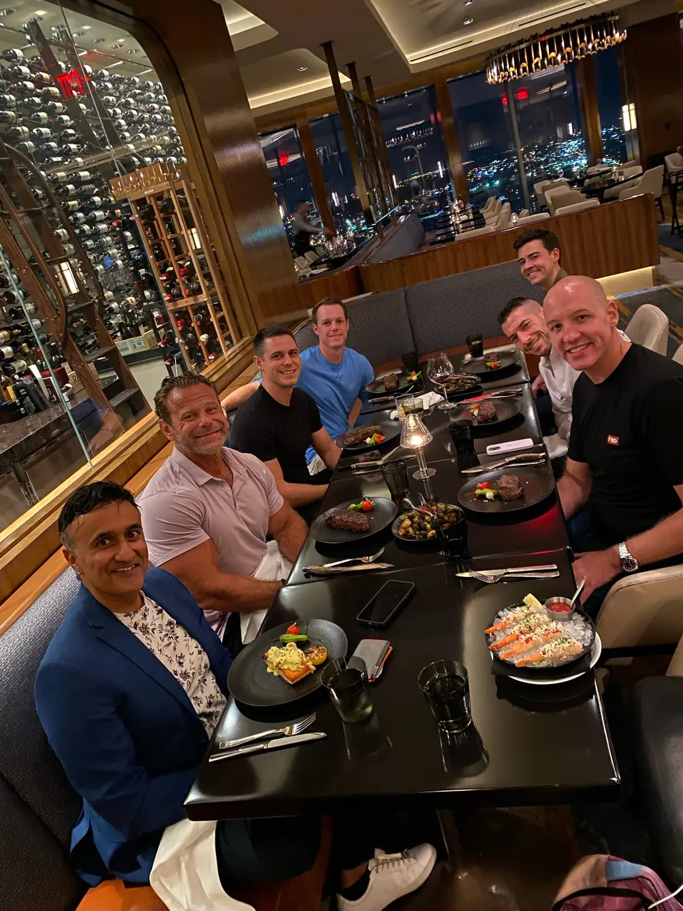 Neo at dinner with a group of people